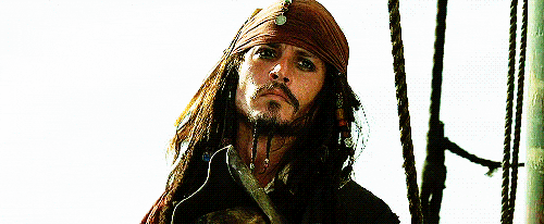 Captain Jack Sparrow waves goodbye with a serious face.