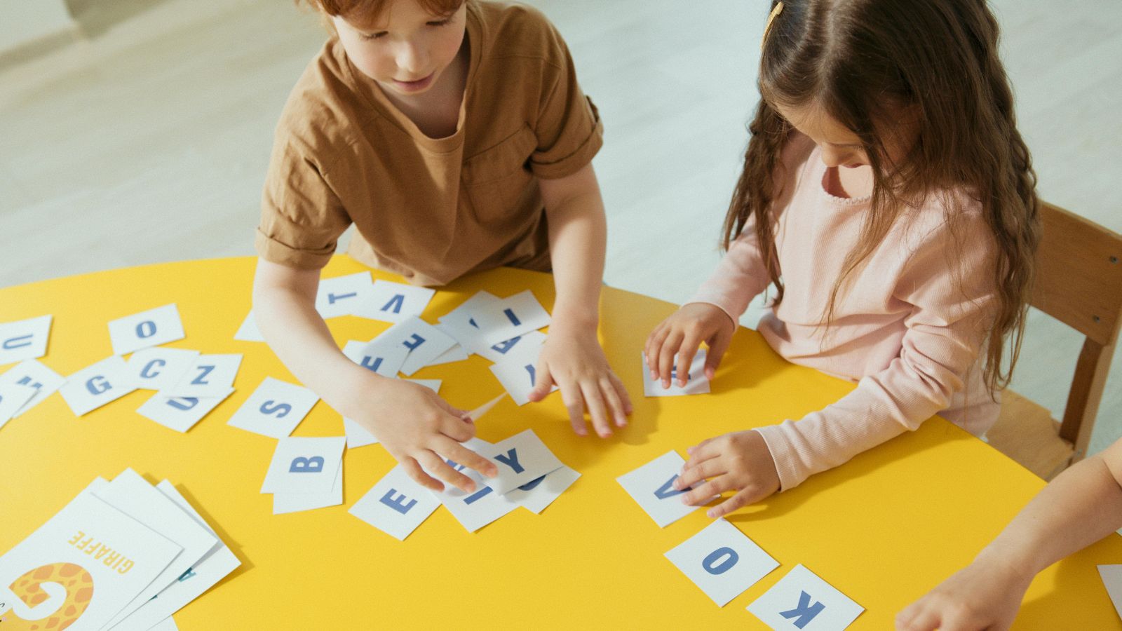 Elementary homeschool children strategically using free educational printables to supplement their learning. TPT resources in action.