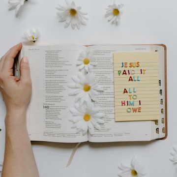 Christian Education - An image of a Bible with notes.