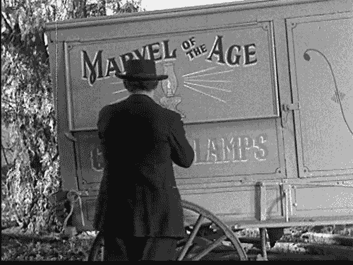 A vintage snake oil salesman shows his wares.